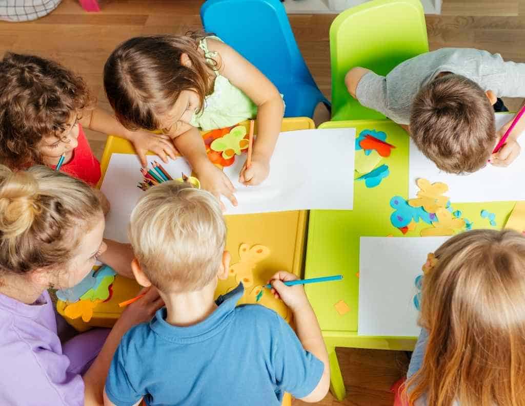 kids making butterfly crafts in Kindergarten classroom